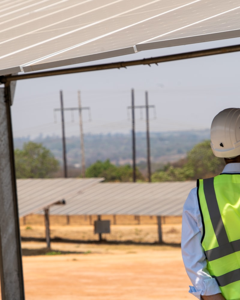 Solar engineer inspecting panels on site